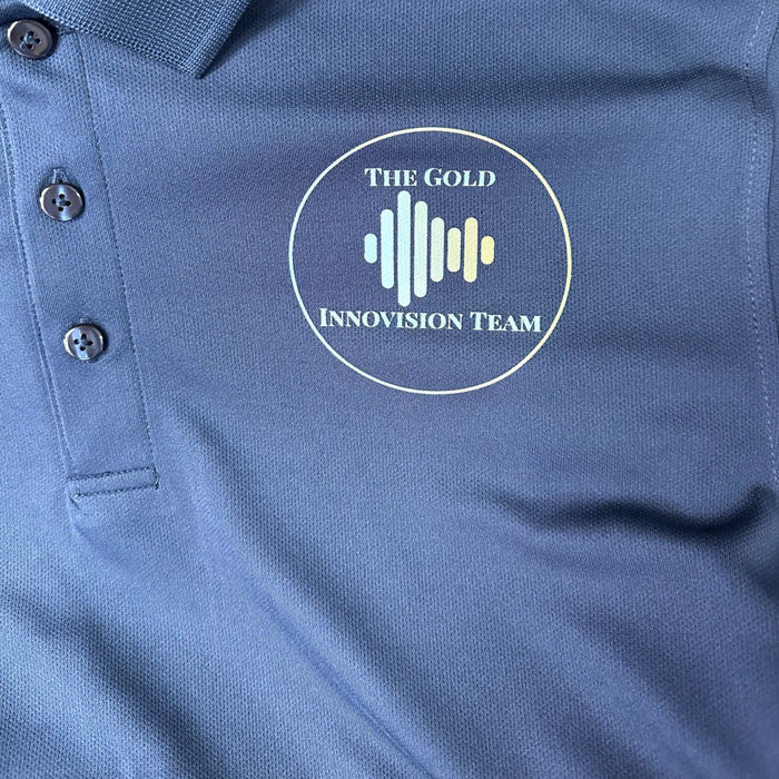 Blue polo shirt branded for The Gold Innovision Team