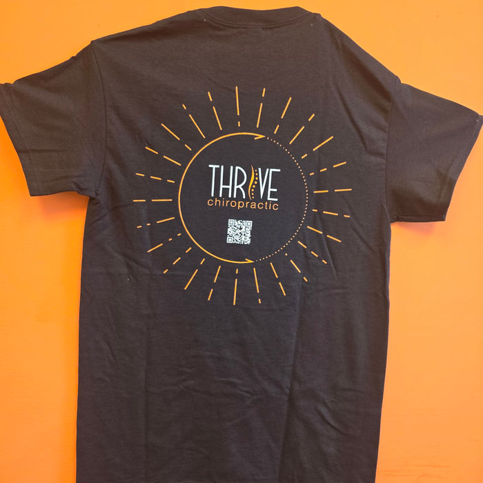 Black t-shirt screen-printed with the Thrive Chiropractic logo
